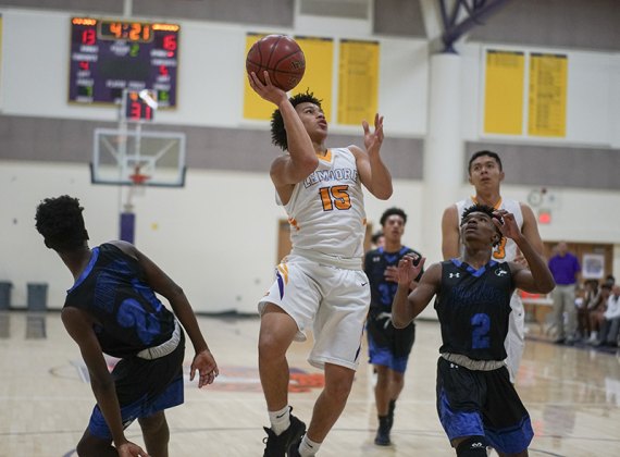 Lemoore's Sean Patrick goes for two points against Hanford West Tuesday night in the school's Event Center.The Tigers beat the Huskies 56-38.